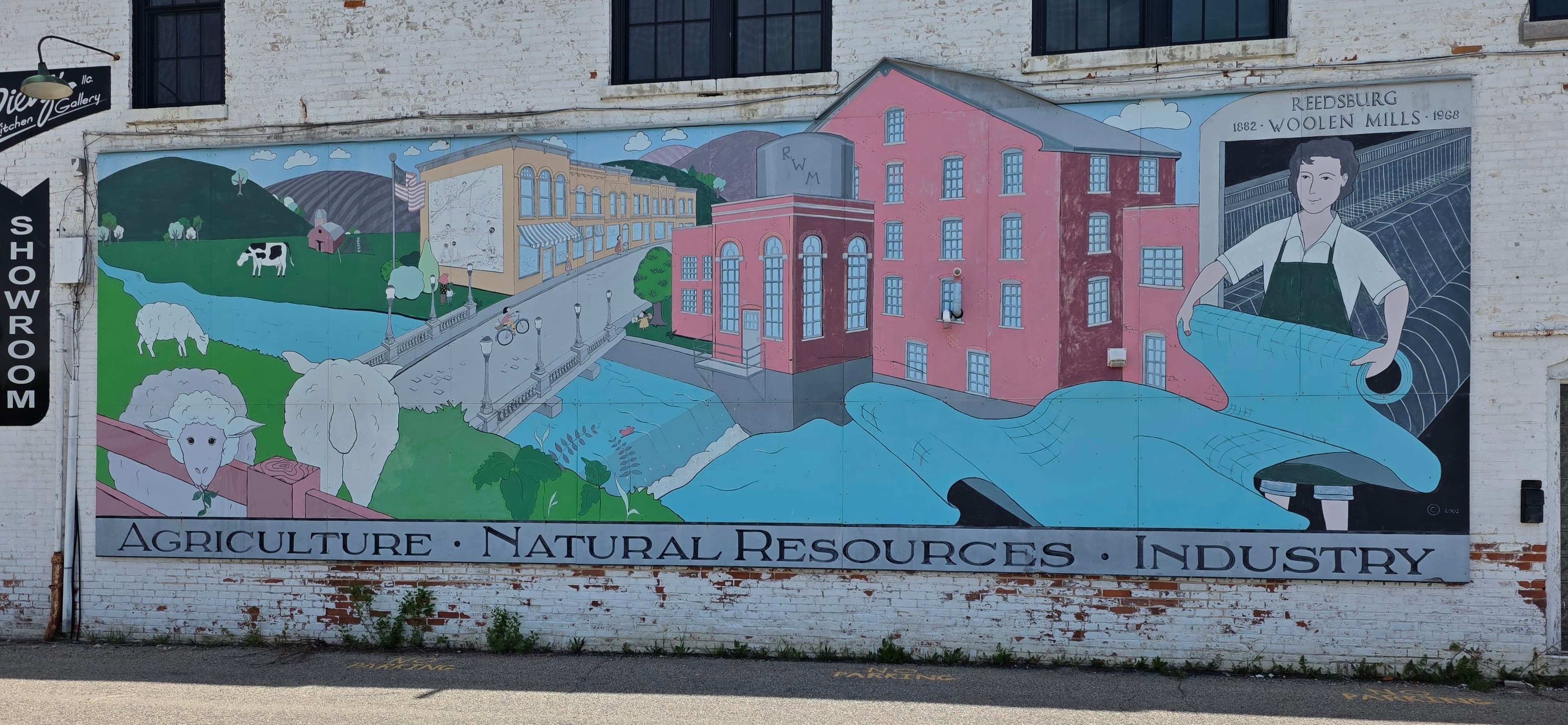 Historic Reedsburg mural showing agriculture, natural resources, and woolen mills heritage