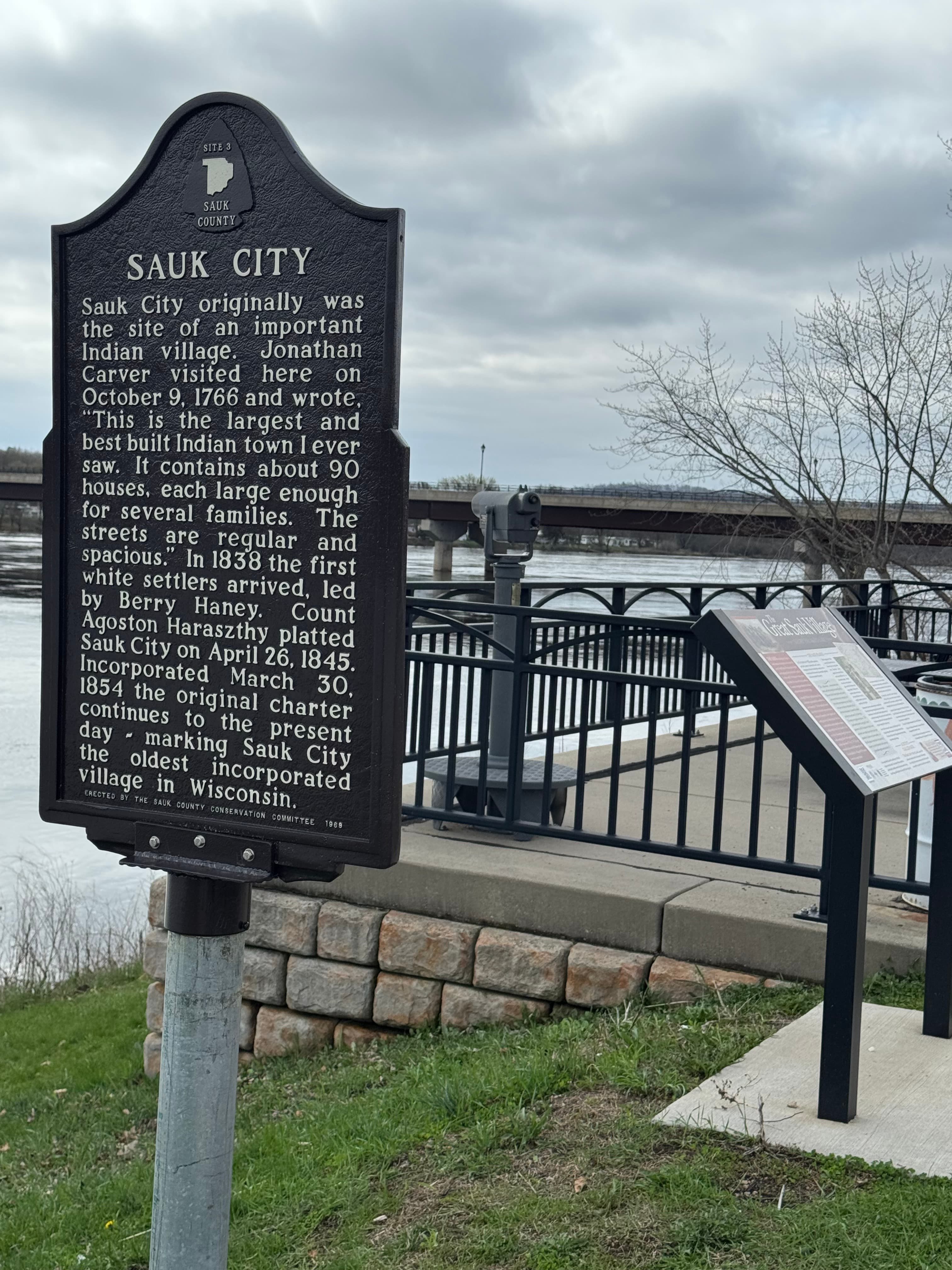 Sauk City historic marker and Wisconsin River, showing the heart of Sauk City's riverfront heritage