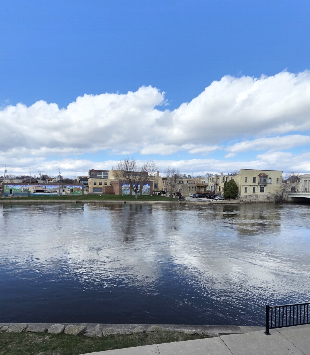 Downtown Fort Atkinson along the Rock River with historic buildings and murals