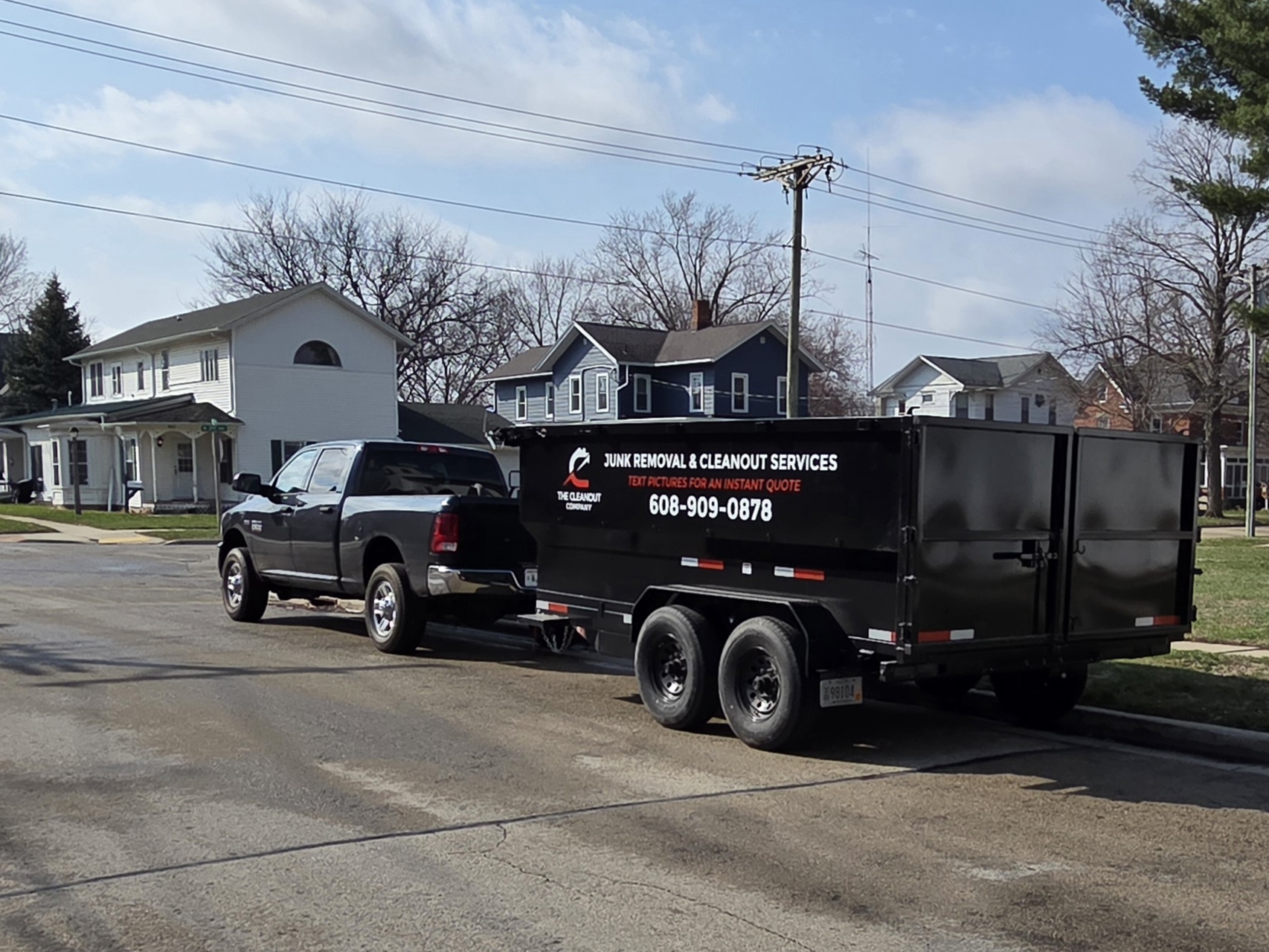 The Cleanout Company junk removal truck and trailer — empty and ready